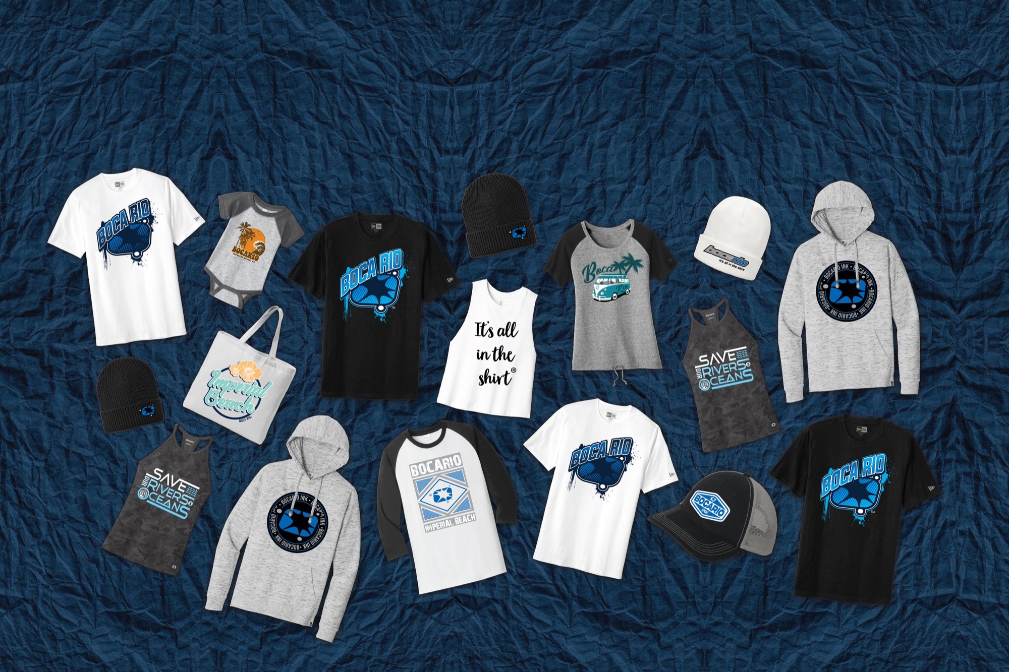 Boca Rio custom printed tees, hoodies, tanks, caps and totes laid out on navy velvet